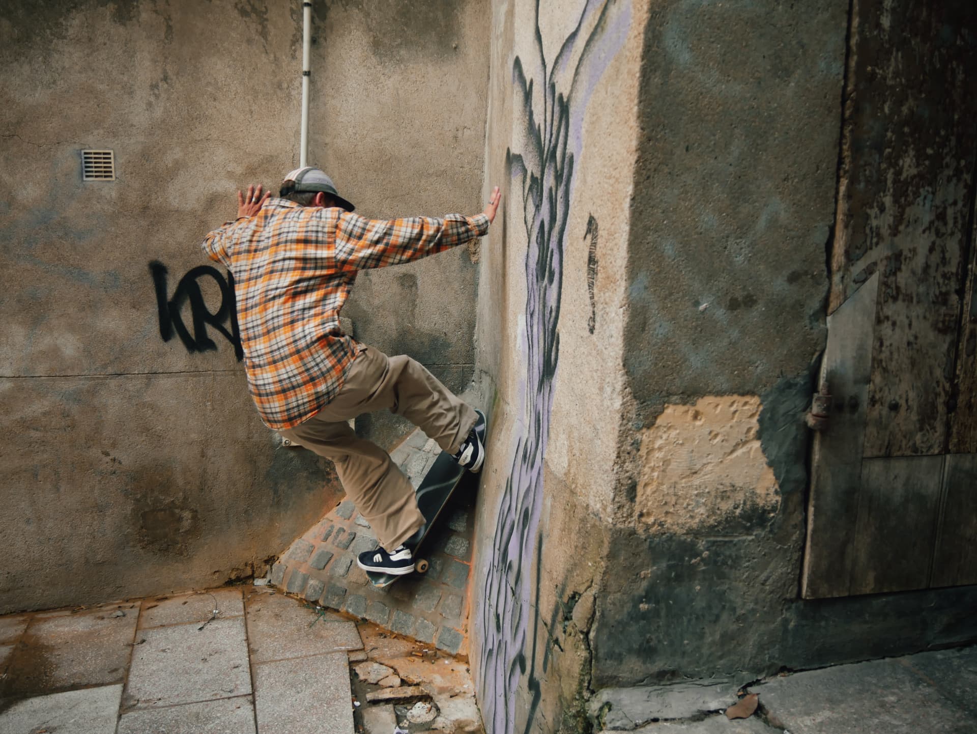 A skateboarder against a wall